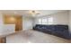 Large living room with theater seating, a ceiling fan, and multiple bright windows at 8747 Flourish Dr, Land O Lakes, FL 34637