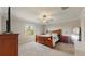 Cozy main bedroom with a ceiling fan, window, and matching dresser sets, offering ample storage at 8747 Flourish Dr, Land O Lakes, FL 34637