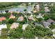Aerial view of home featuring tile roof, screened pool, mature trees, and beautiful neighborhood at 9116 Woodridge Run Dr, Tampa, FL 33647