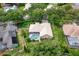 Aerial view of home featuring a screened pool, tile roof, mature trees, and well-maintained landscaping at 9116 Woodridge Run Dr, Tampa, FL 33647