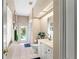 Bright bathroom featuring a single vanity, a door to the pool, and natural light from a window at 9116 Woodridge Run Dr, Tampa, FL 33647