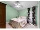 Charming bedroom with a floral bedspread, natural light, and soft carpet at 9116 Woodridge Run Dr, Tampa, FL 33647