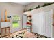 Bright bedroom featuring wood-look floors, a window, and a closet at 9116 Woodridge Run Dr, Tampa, FL 33647