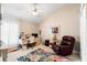 Comfortable bedroom setup as an office space, featuring a chair and desk at 9116 Woodridge Run Dr, Tampa, FL 33647