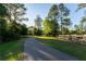 Community path with benches winding through a park-like setting, surrounded by lush greenery at 9116 Woodridge Run Dr, Tampa, FL 33647