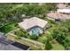 Home with a screened pool, tile roof, well-manicured lawn, landscaping and white picket fence at 9116 Woodridge Run Dr, Tampa, FL 33647