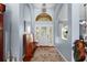 Bright foyer with hardwood floors, high ceilings, bench seating, and a decorative chandelier at 9116 Woodridge Run Dr, Tampa, FL 33647