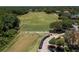 Aerial view of the golf course driving range, surrounded by lush greenery at 9116 Woodridge Run Dr, Tampa, FL 33647