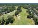 A scenic aerial view showing a lush golf course with sand traps and mature landscaping at 9116 Woodridge Run Dr, Tampa, FL 33647