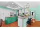 Bright kitchen featuring white cabinets, a large island with a wooden countertop, and hardwood floors at 9116 Woodridge Run Dr, Tampa, FL 33647