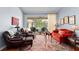 Comfortable living room with hardwood floors, a large sliding glass door, and views of the screened pool at 9116 Woodridge Run Dr, Tampa, FL 33647