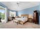 Tranquil main bedroom features plush carpeting, soft natural light, and a cozy seating area at 9116 Woodridge Run Dr, Tampa, FL 33647