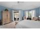 Bright main bedroom with pool access, neutral carpet, and ample natural light at 9116 Woodridge Run Dr, Tampa, FL 33647