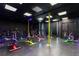 Modern spin studio with rows of stationary bikes and colored lighting to create an engaging workout atmosphere at 9116 Woodridge Run Dr, Tampa, FL 33647