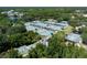 A high aerial shot showing multiple tennis courts and landscaping in a neighborhood at 9116 Woodridge Run Dr, Tampa, FL 33647