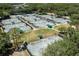 Aerial view showing an extensive tennis complex, including multiple courts with shaded seating at 9116 Woodridge Run Dr, Tampa, FL 33647