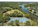 Aerial view of the community tennis courts next to the lake at 9116 Woodridge Run Dr, Tampa, FL 33647