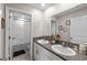 Double sink bathroom with granite countertops, white cabinets, and decorative wall accents at 9334 Lemon Drop Loop, Sun City Center, FL 33573