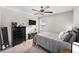 Comfortable bedroom featuring a ceiling fan, dresser, television, and window with blinds at 9334 Lemon Drop Loop, Sun City Center, FL 33573
