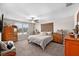 Spacious bedroom featuring a ceiling fan, ample storage, and a window with blinds at 9334 Lemon Drop Loop, Sun City Center, FL 33573