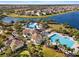 Aerial of community pool, clubhouse and recreation area with mature landscaping and seating at 9334 Lemon Drop Loop, Sun City Center, FL 33573