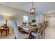 Elegant dining room with a wooden table, chandelier, and neutral decor for a welcoming atmosphere at 9334 Lemon Drop Loop, Sun City Center, FL 33573
