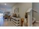 Bright hallway with stylish decor, leading to the dining room and featuring stairway access to upper floors at 9334 Lemon Drop Loop, Sun City Center, FL 33573
