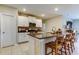Open kitchen layout with a large island, stainless steel appliances, and ample white cabinetry at 9334 Lemon Drop Loop, Sun City Center, FL 33573