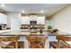 Bright kitchen island with granite countertops, stainless steel appliances, and modern white cabinetry at 9334 Lemon Drop Loop, Sun City Center, FL 33573