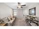 Cozy living room with comfortable sofa, a decorative console table, and a ceiling fan at 9334 Lemon Drop Loop, Sun City Center, FL 33573