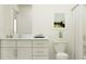 Bright bathroom features a shower with white cabinets, and a white marble countertop at 9437 Raised Tulip Ln, Land O Lakes, FL 34637