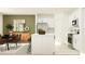 Modern open kitchen with white cabinets, stainless steel appliances, a kitchen island, and adjacent dining area at 9437 Raised Tulip Ln, Land O Lakes, FL 34637