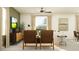 Comfortable living area with stylish furnishings, including wood cabinets, complemented by natural light from the windows at 9437 Raised Tulip Ln, Land O Lakes, FL 34637