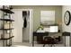 Stylish home office with sleek black desk, open shelving, and a neutral color palette at 9437 Raised Tulip Ln, Land O Lakes, FL 34637