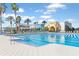 Stunning community pool surrounded by lush landscaping and comfortable lounge chairs at 9437 Raised Tulip Ln, Land O Lakes, FL 34637