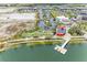 Community aerial view showcasing modern buildings, commercial area, parking, playground, and a waterfront area at 1857 N San Mateo Dr, North Port, FL 34288