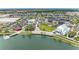 Stunning aerial view of the community with its scenic lake and beautifully designed buildings at 1857 N San Mateo Dr, North Port, FL 34288
