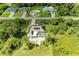 Aerial view showing this property's solar panels, screened pool, lush landscaping, and neighborhood setting at 1857 N San Mateo Dr, North Port, FL 34288