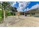 Spacious backyard featuring shell landscaping, a screened patio, and potential outdoor living space at 1857 N San Mateo Dr, North Port, FL 34288