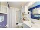 Well-lit bathroom featuring a shower, vanity, and ample storage space at 1857 N San Mateo Dr, North Port, FL 34288