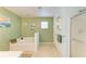Relaxing bathroom featuring a large soaking tub, shower, and natural light at 1857 N San Mateo Dr, North Port, FL 34288