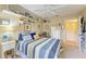 Bright bedroom featuring a striped bedspread, white shelving, and ample natural light at 1857 N San Mateo Dr, North Port, FL 34288