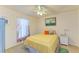 Comfortable bedroom with a yellow bedspread and a serene, inviting atmosphere at 1857 N San Mateo Dr, North Port, FL 34288