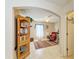 Bright bonus room featuring a ceiling fan, tile flooring, and an archway to the hallway at 1857 N San Mateo Dr, North Port, FL 34288