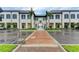 Attractive building exterior with classic architectural details, palm trees, and a brick-paved walkway at 1857 N San Mateo Dr, North Port, FL 34288