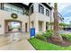 Elegant building exterior featuring classic architecture, lush landscaping, and a welcoming entrance with a decorative wreath at 1857 N San Mateo Dr, North Port, FL 34288