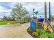 Well-maintained Mellon Park with lush landscaping, paved pathways, and a sign directing visitors to various amenities at 1857 N San Mateo Dr, North Port, FL 34288