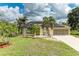 Charming home with a well-manicured lawn, solar panels, and an attached two-car garage at 1857 N San Mateo Dr, North Port, FL 34288