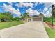Home exterior showcases solar panels, a concrete driveway, and an attached two-car garage at 1857 N San Mateo Dr, North Port, FL 34288