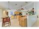 Bright kitchen features natural wood cabinets, tiled floor, and two islands providing ample workspace at 1857 N San Mateo Dr, North Port, FL 34288
